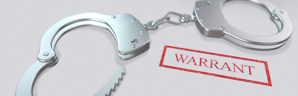 handcuffs and red stamp warrant