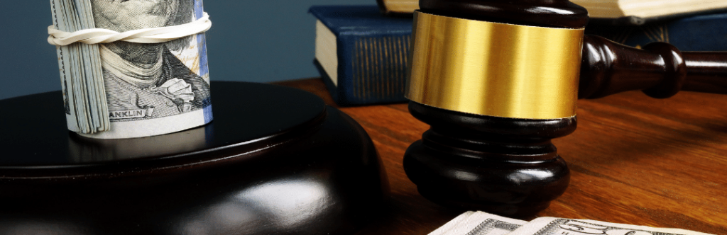 gavel stacks of money and books on table