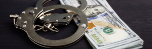 handcuffs on top of money stack