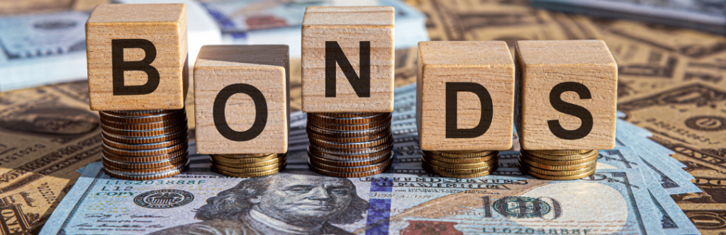 blocks that spell bonds on top of stacks of money and coins