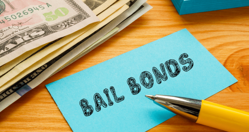 paper with bail bonds written next to stack of money